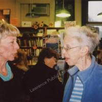 Photograph of Lee Harris and Beth Schultz at the Commerce Ribbon Cutting at Raven Bookstore, 1980.