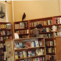 Photograph of Michael Seiwert and the Bookshelf Raven at Raven Bookstore on Opening Day, 1987.